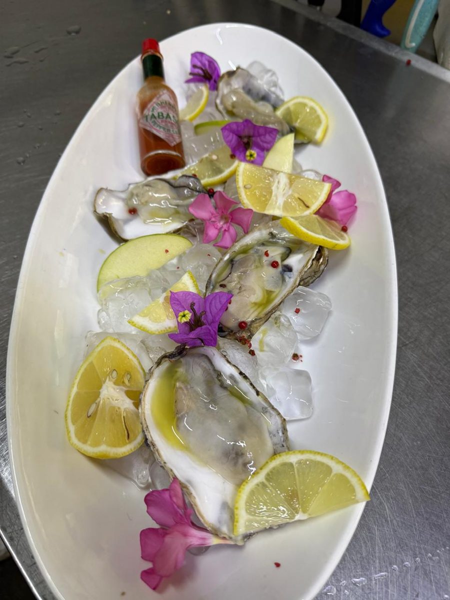 Oysters on ice with lemon and flowers